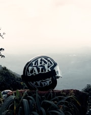 A close-up of a biker helmet resting on a motorcycle seat, symbolizing adventure and safety.