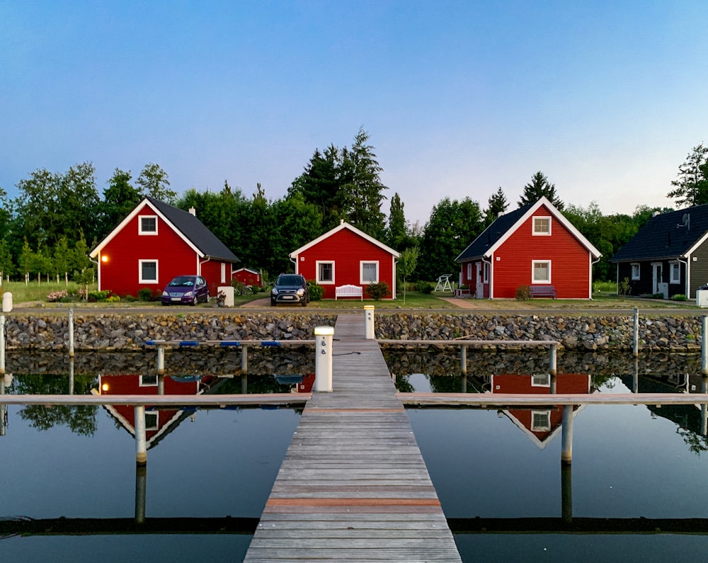 red and white house near body of water during daytime