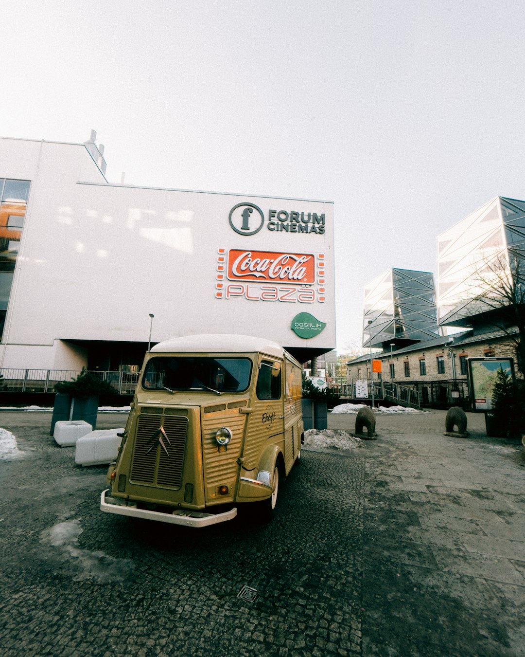 brown volkswagen t-2 van parked beside white building during daytime