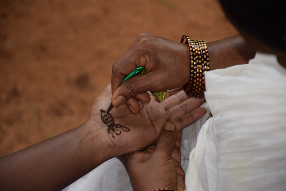 person holding green leaf plant