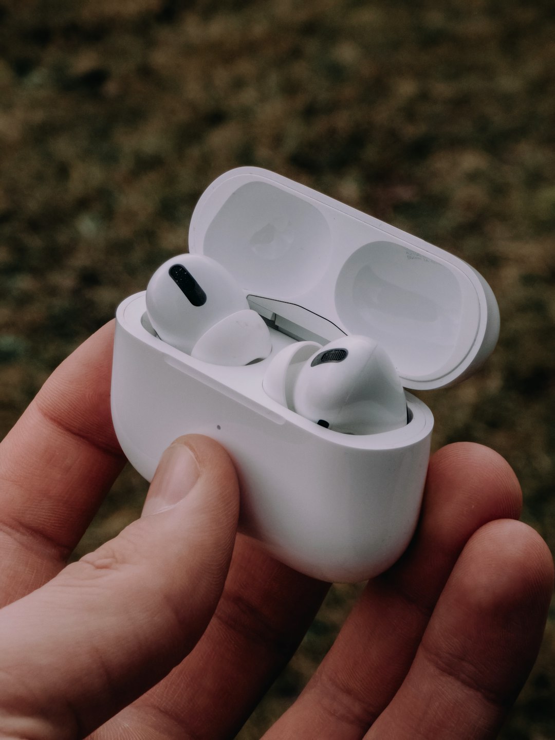 person holding white apple earpods