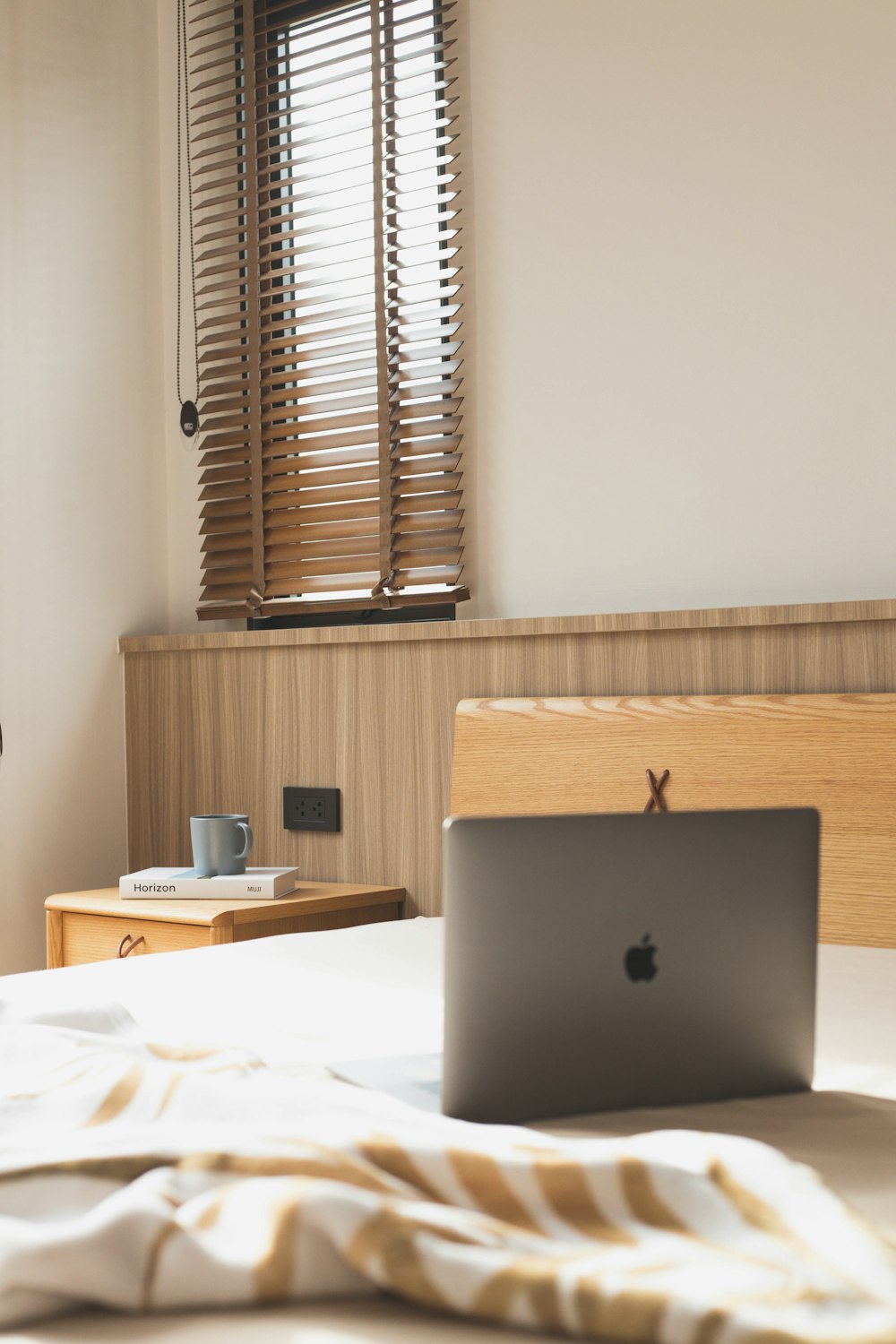 silver macbook on white table