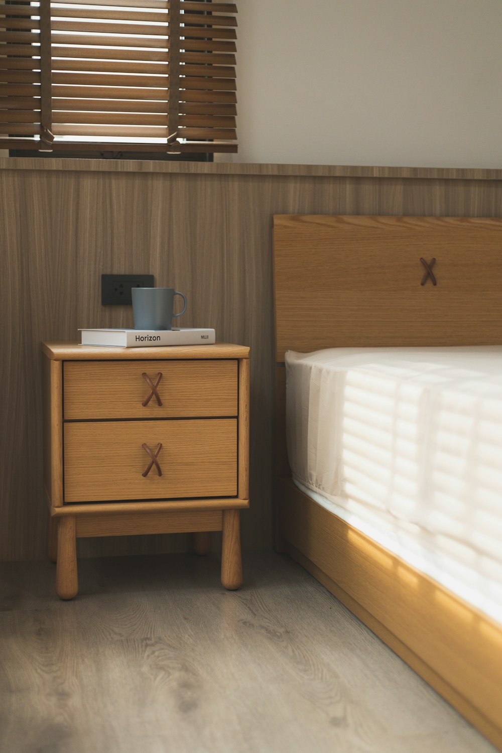 brown wooden drawer beside bed