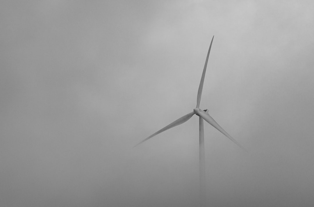 white wind turbine under white sky