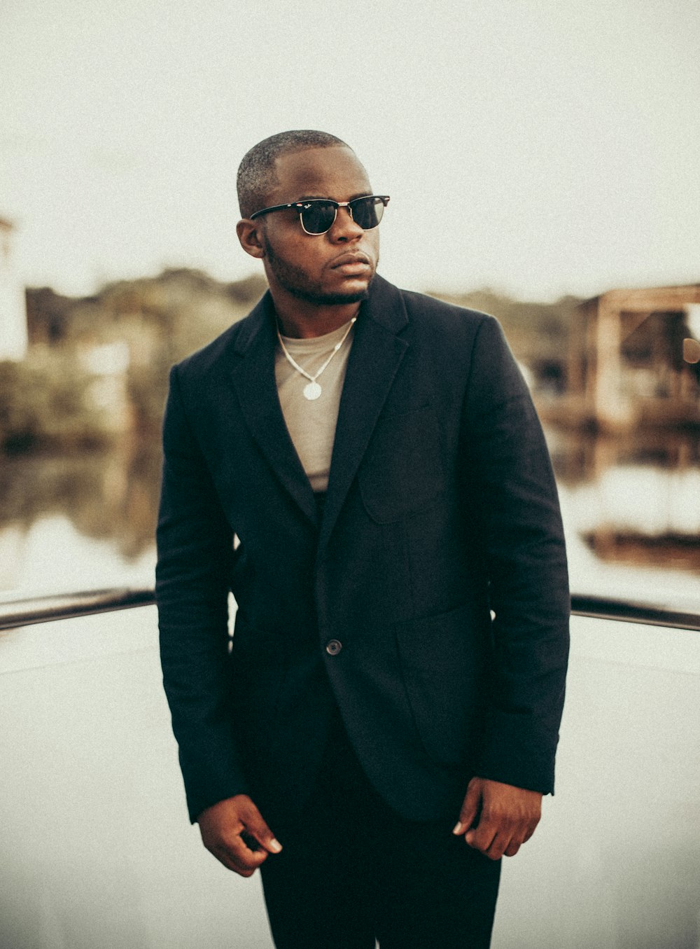 man in blue suit jacket wearing black sunglasses