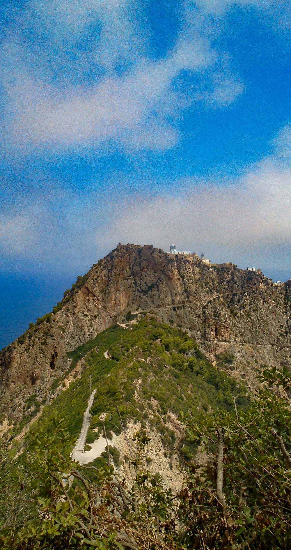 green and brown mountain under blue sky