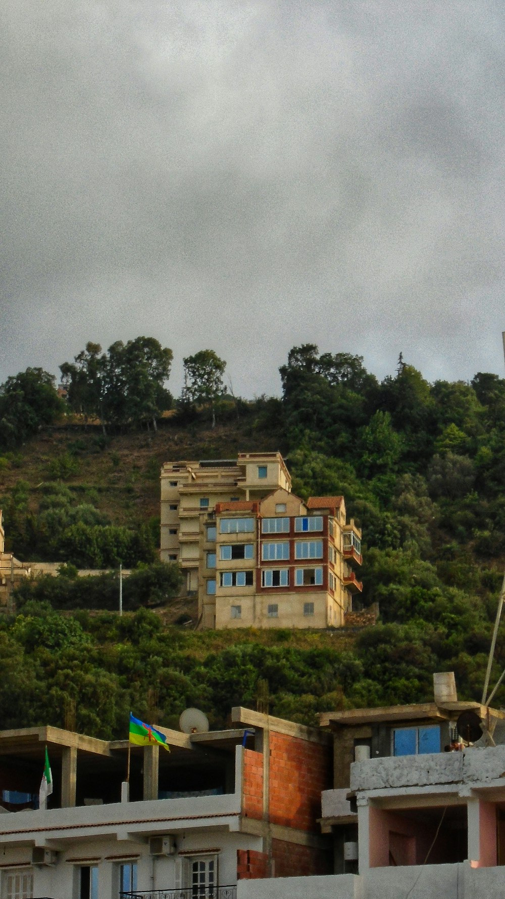 brown concrete building near green trees during daytime