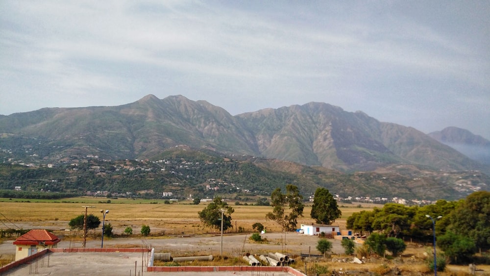 green grass field near mountain during daytime