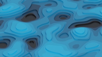 Layered abstract design featuring a series of curved and flowing shapes resembling a topographic map. Predominant use of blue hues with variations in shade creating a sense of depth.