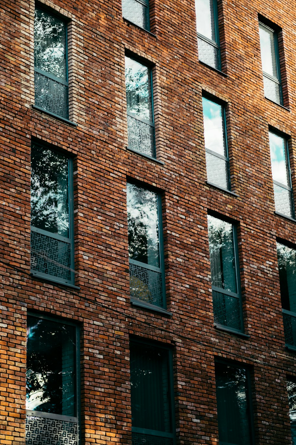 brown brick building with black wooden window