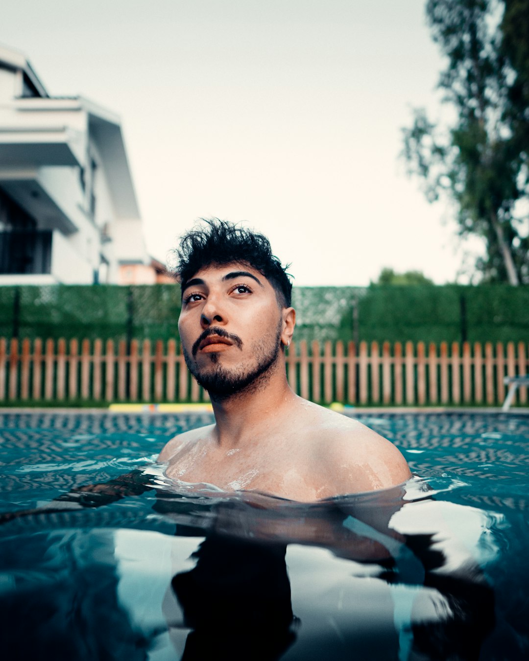man in swimming pool during daytime