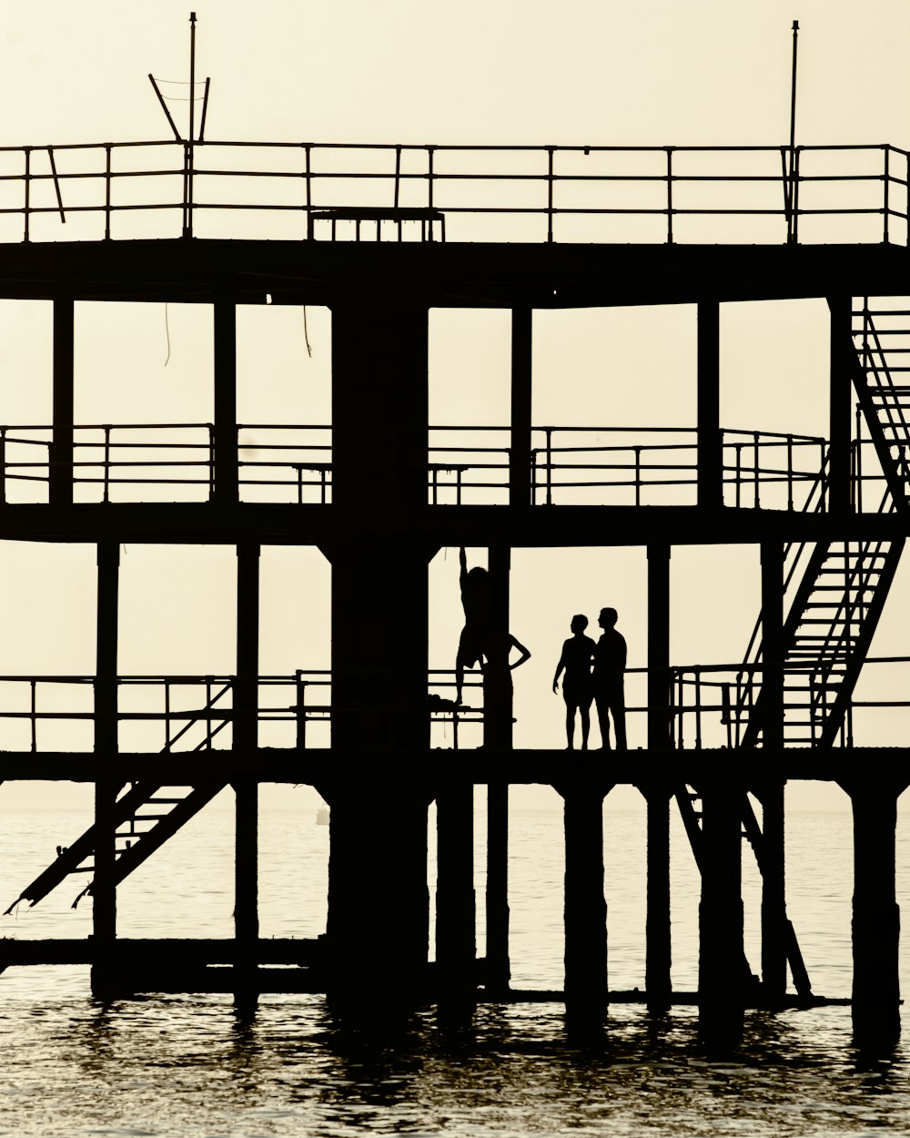 silhouette of people standing on building during daytime