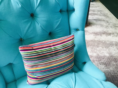 A plush upholstered dining chair in a vibrant color.