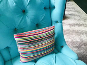 Foam floor tiles arranged in a playful pattern beneath a faux leather accent chair.