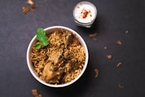 white ceramic bowl with green leaf