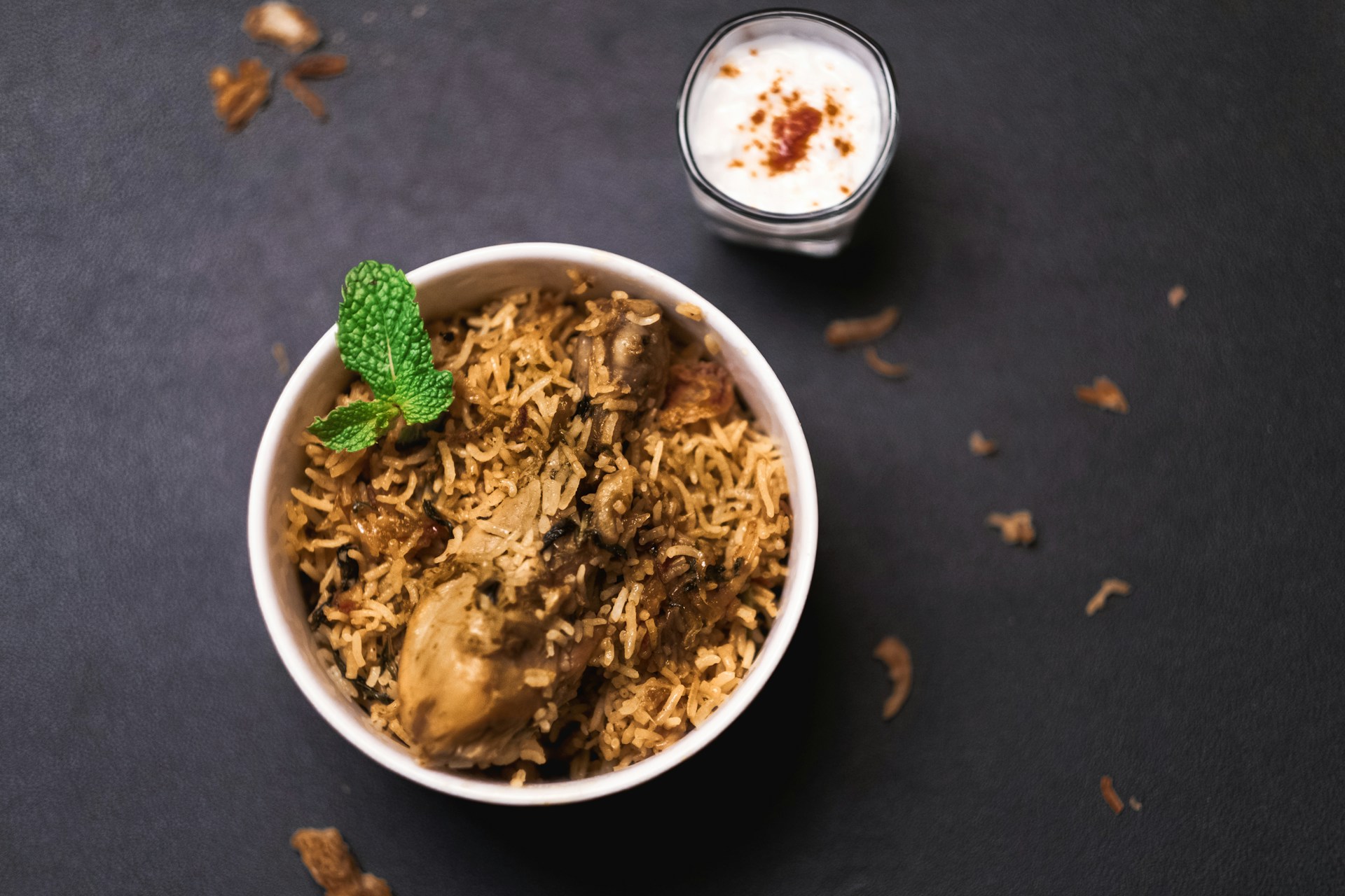 white ceramic bowl with green leaf