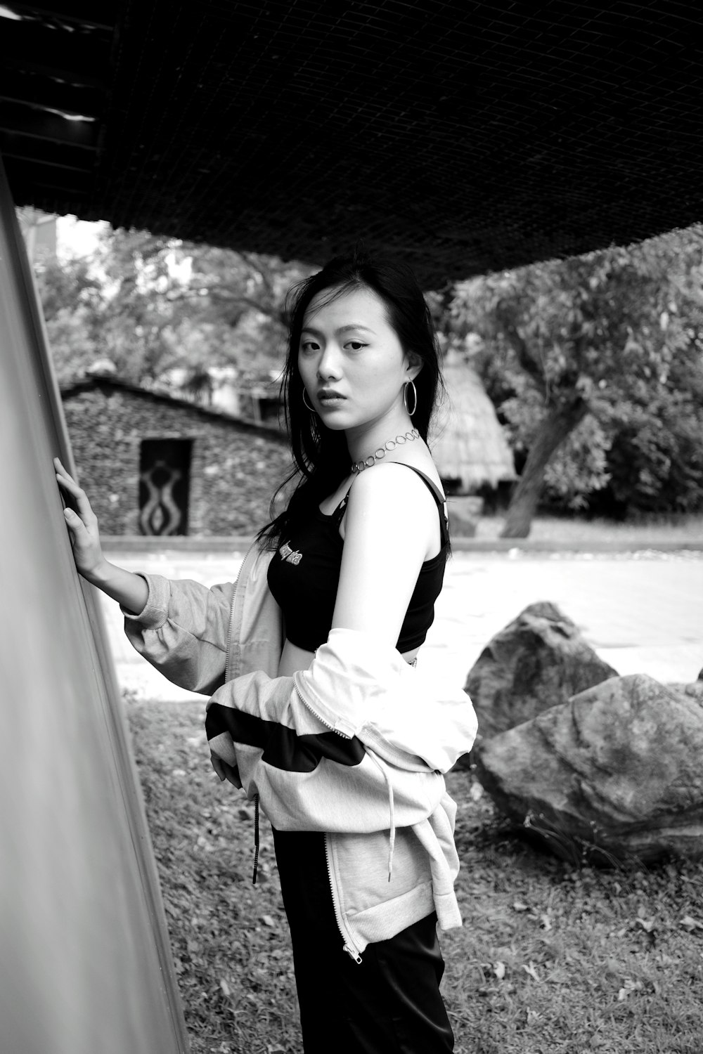 woman in white and black dress standing near body of water during daytime