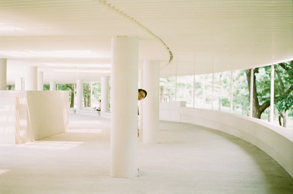 white concrete pillar with white pendant lamp