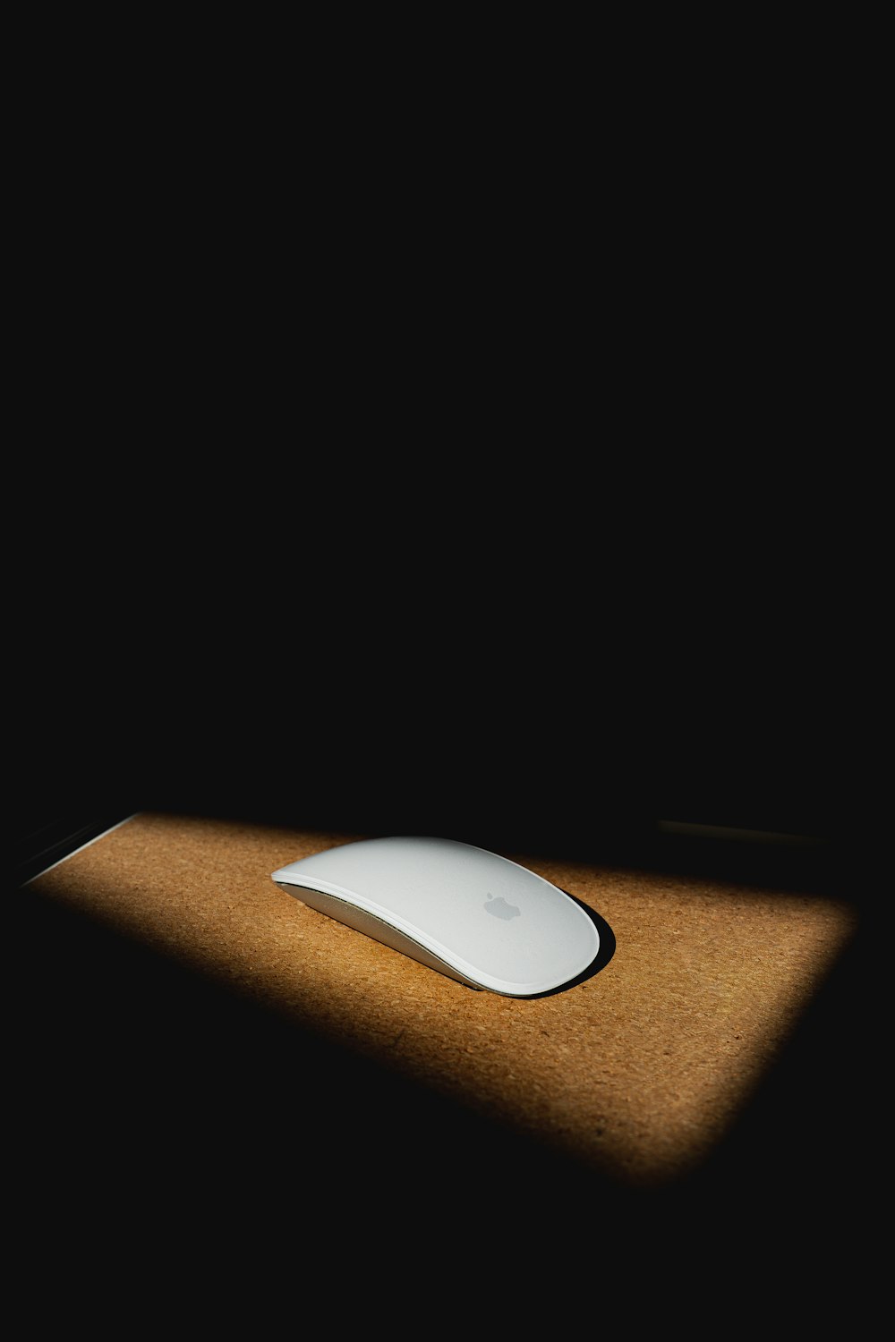 apple magic mouse on brown wooden table
