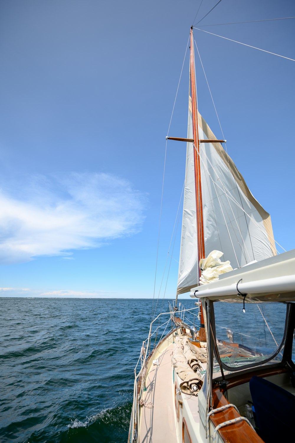 white sail boat on sea during daytime