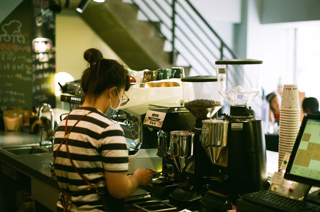 woman in white and black stripe shirt cooking