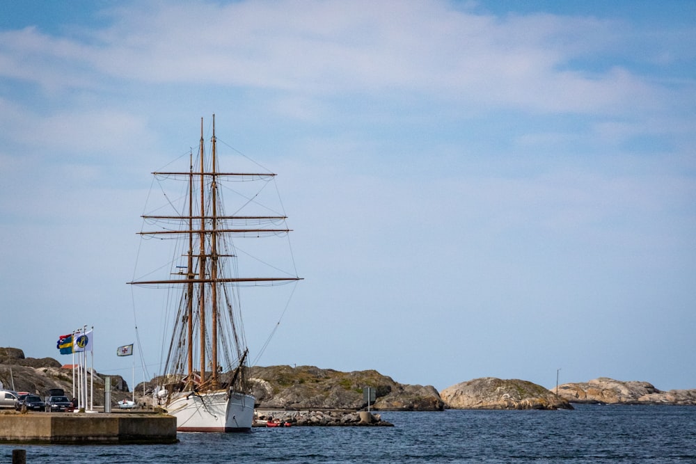 white sail boat on sea during daytime