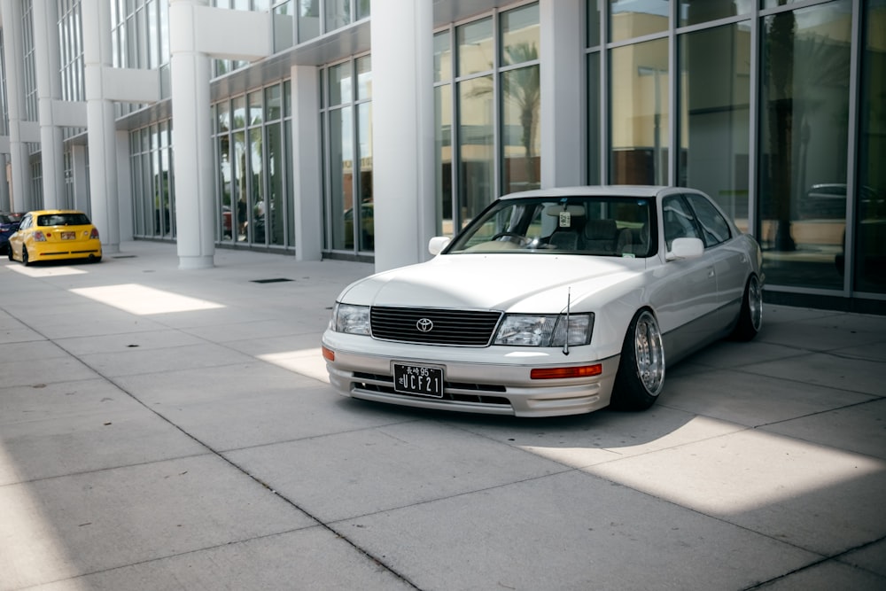 silver mercedes benz coupe parked near white building during daytime