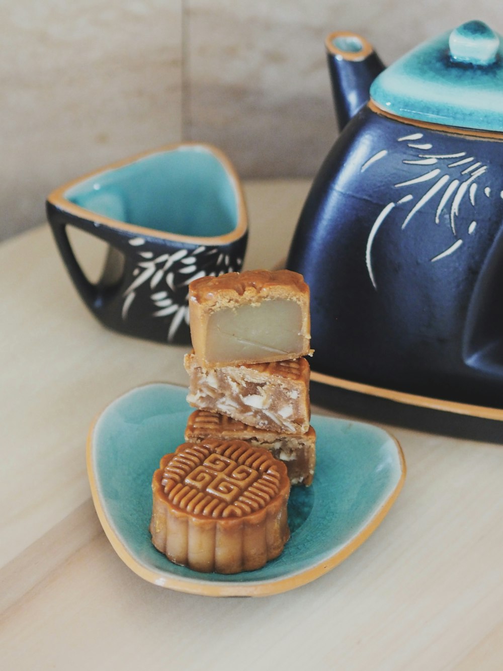 brown and blue ceramic mug on blue ceramic saucer