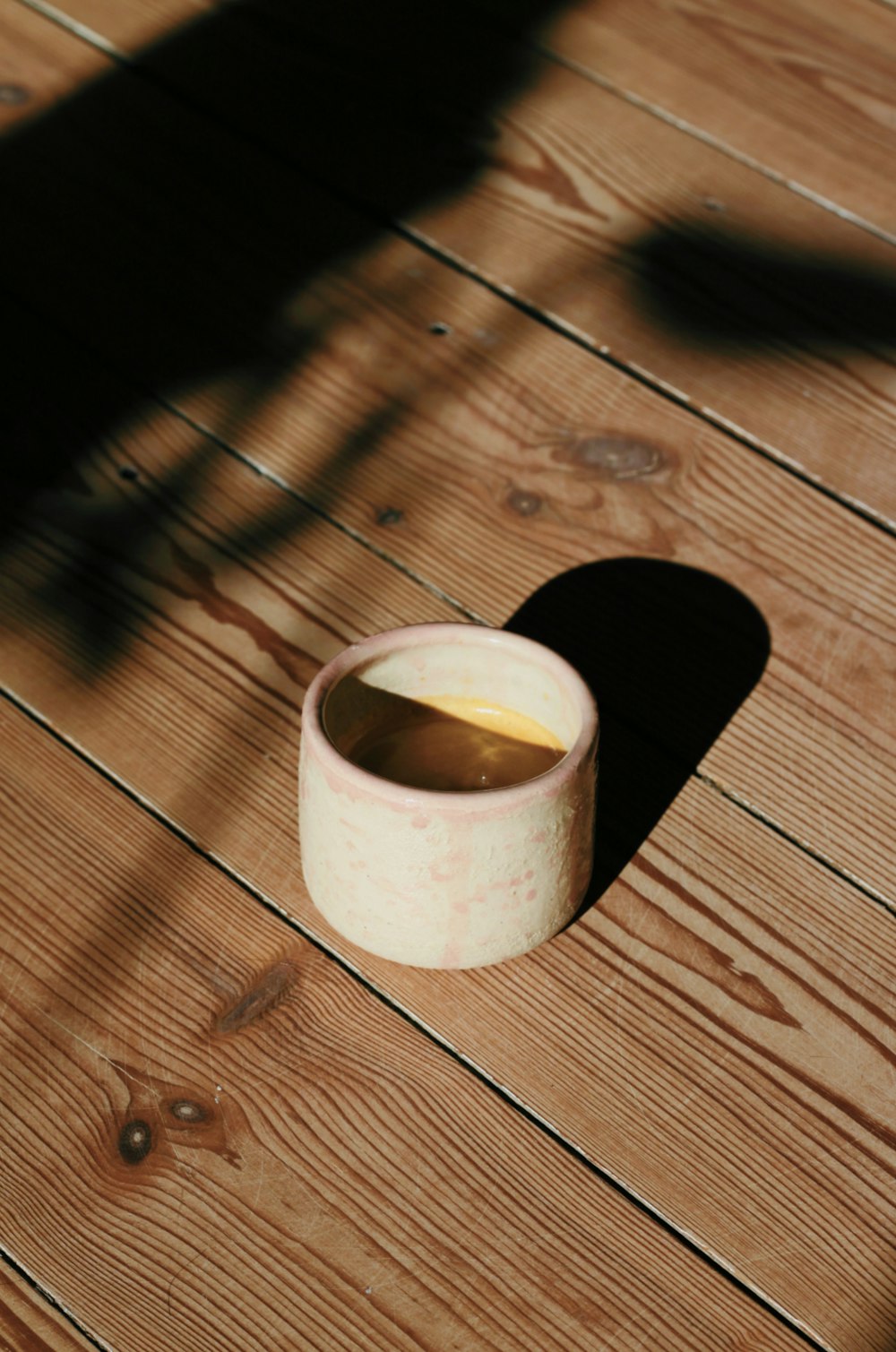 white ceramic mug on brown wooden table