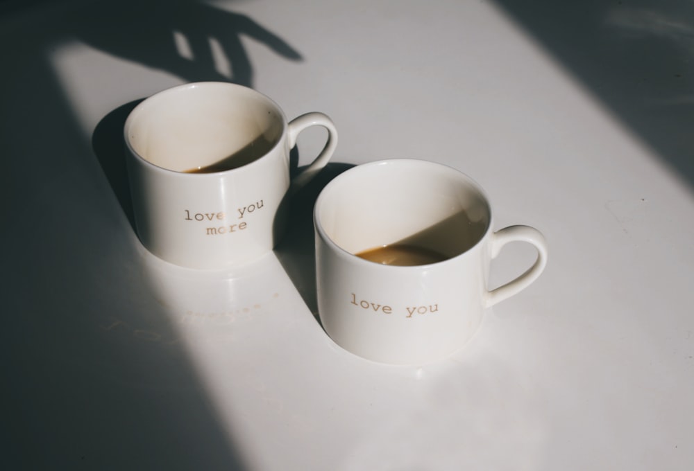 white ceramic mug on white table