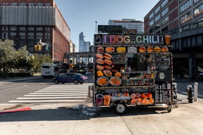 Close-up of a vibrant street food dish served from a colorful food cart