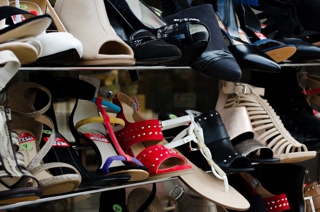 black and white leather peep toe heeled shoes, shoes on a shoe rack