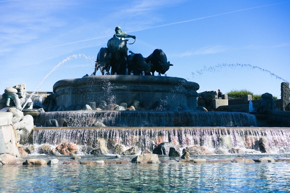 man riding horse statue on water fountain during daytime