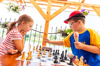boy in blue t-shirt playing chess