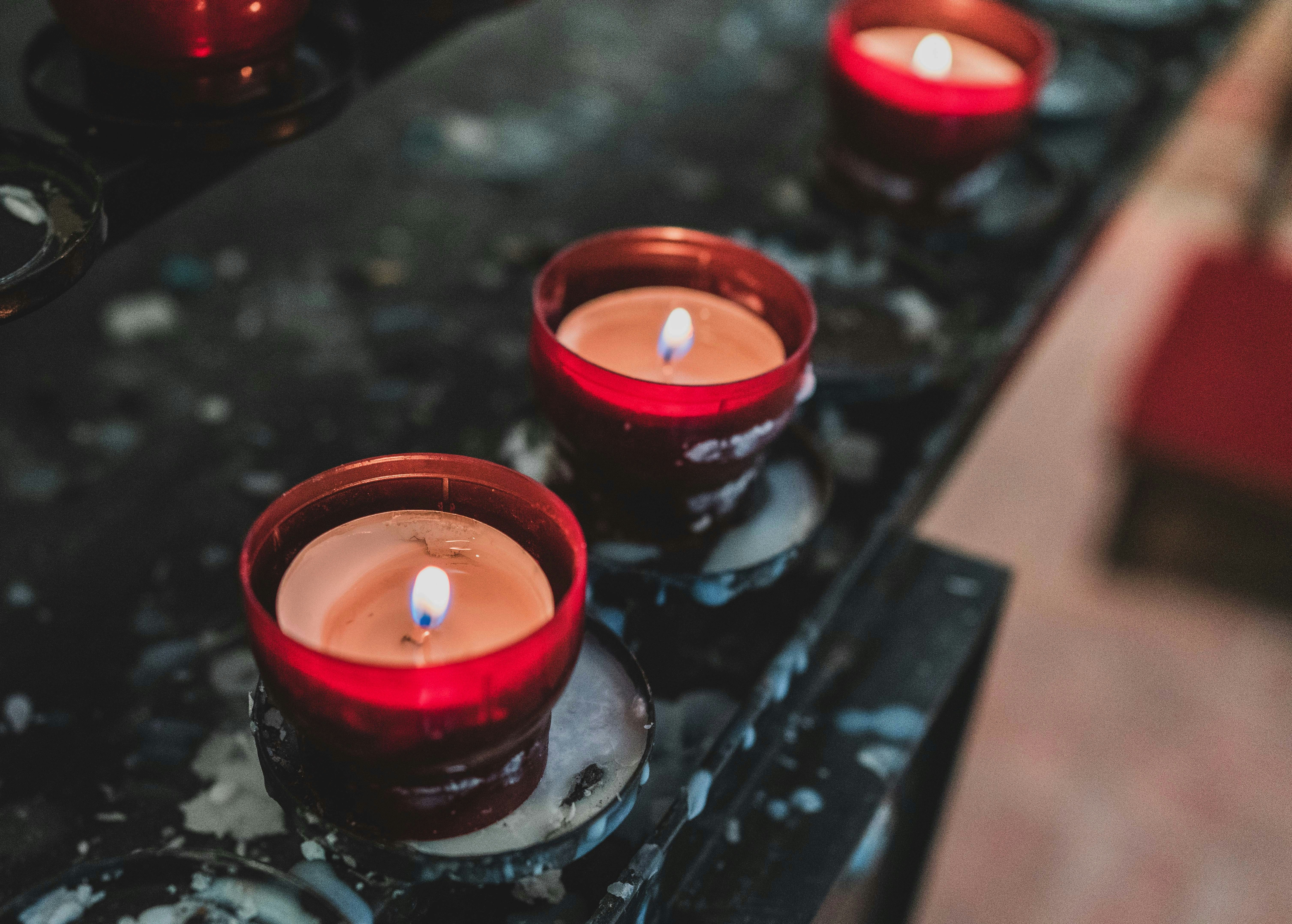 red candles on black surface