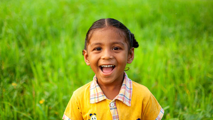 Happy young girl laughing outdoors