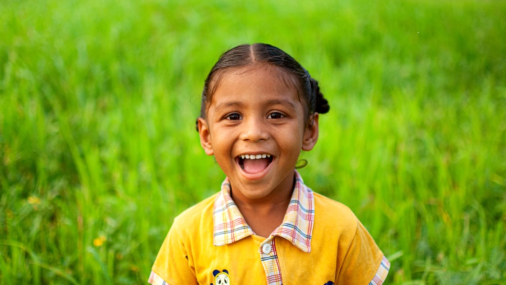 girl in yellow polo shirt smiling