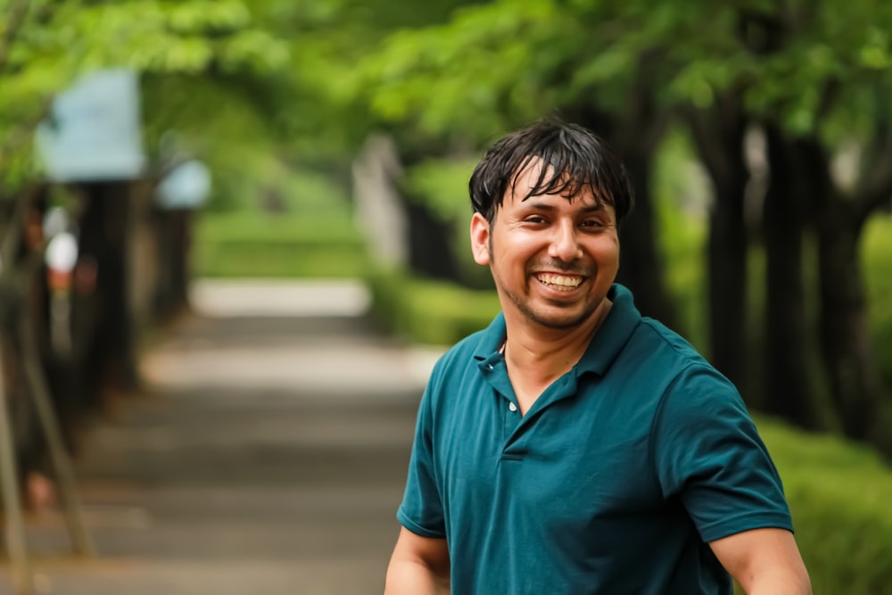 man in blue polo shirt smiling