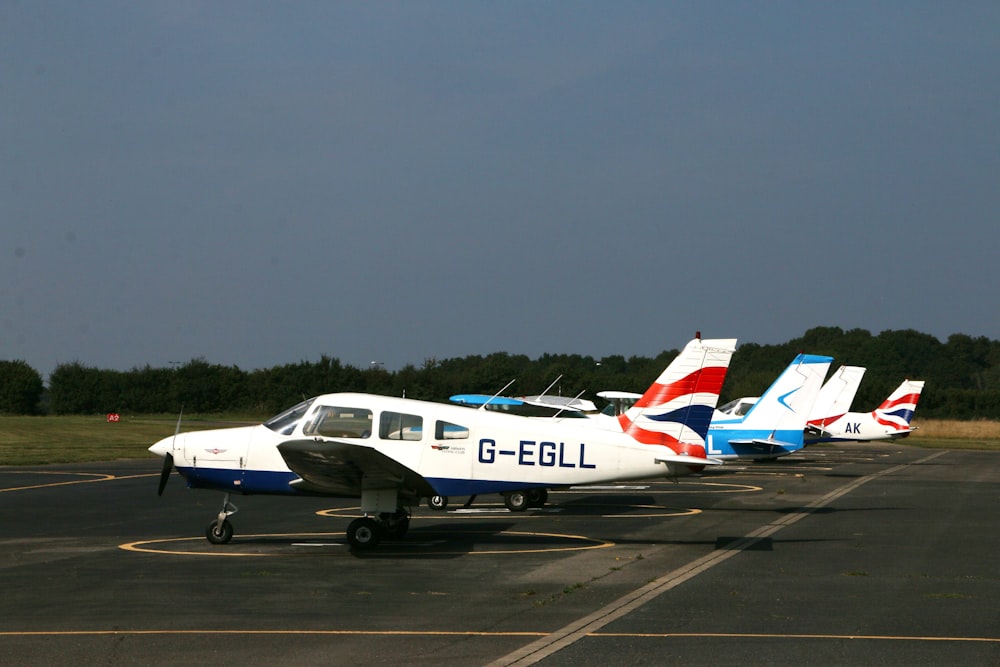 white and blue passenger plane on airport during daytime