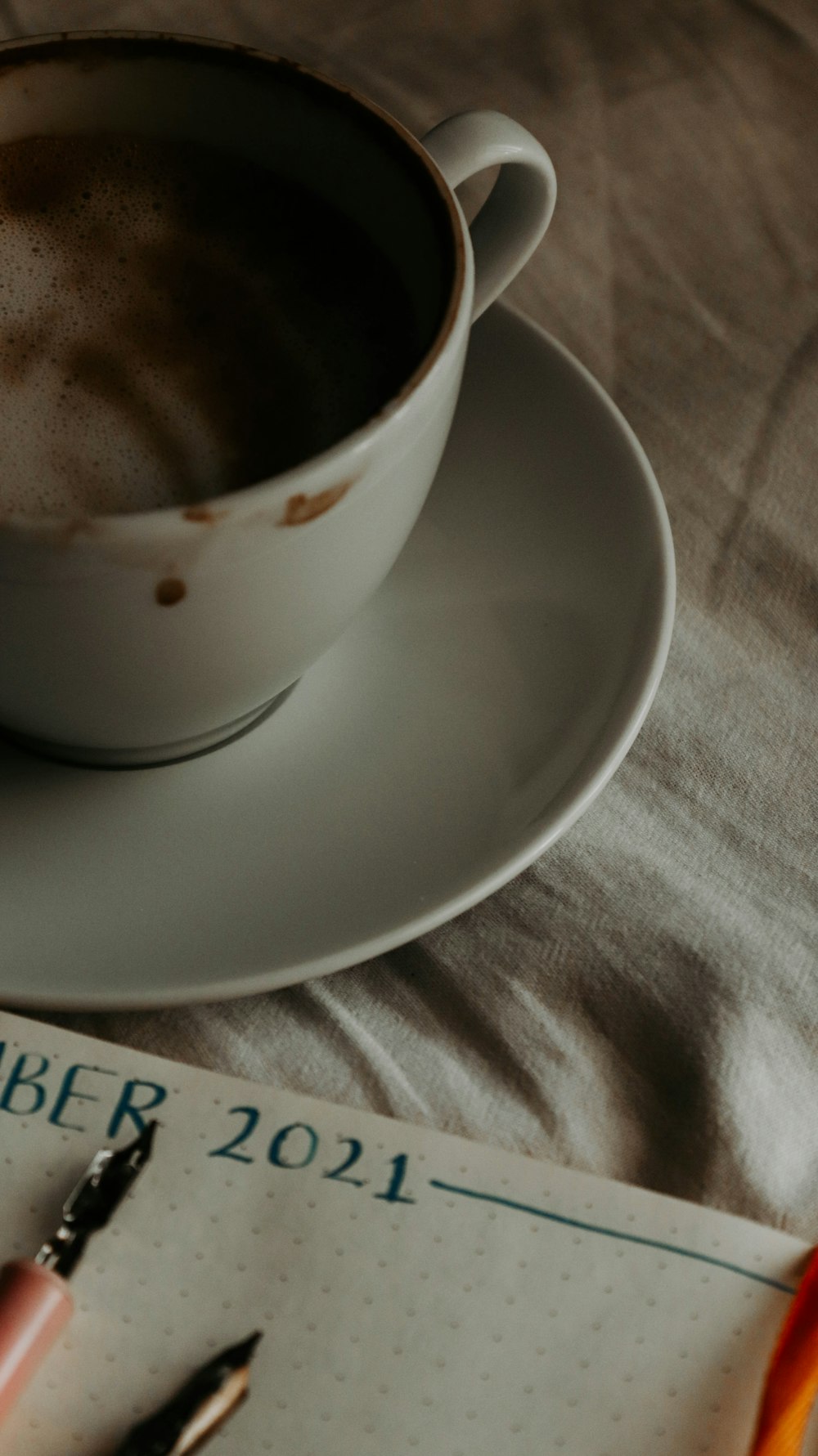 white ceramic teacup on white ceramic saucer