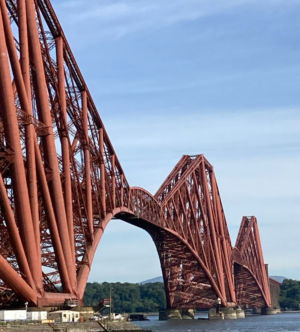 brown metal bridge under blue sky during daytime