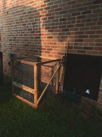 brown wooden crate beside brown brick wall