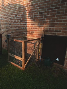 brown wooden crate beside brown brick wall