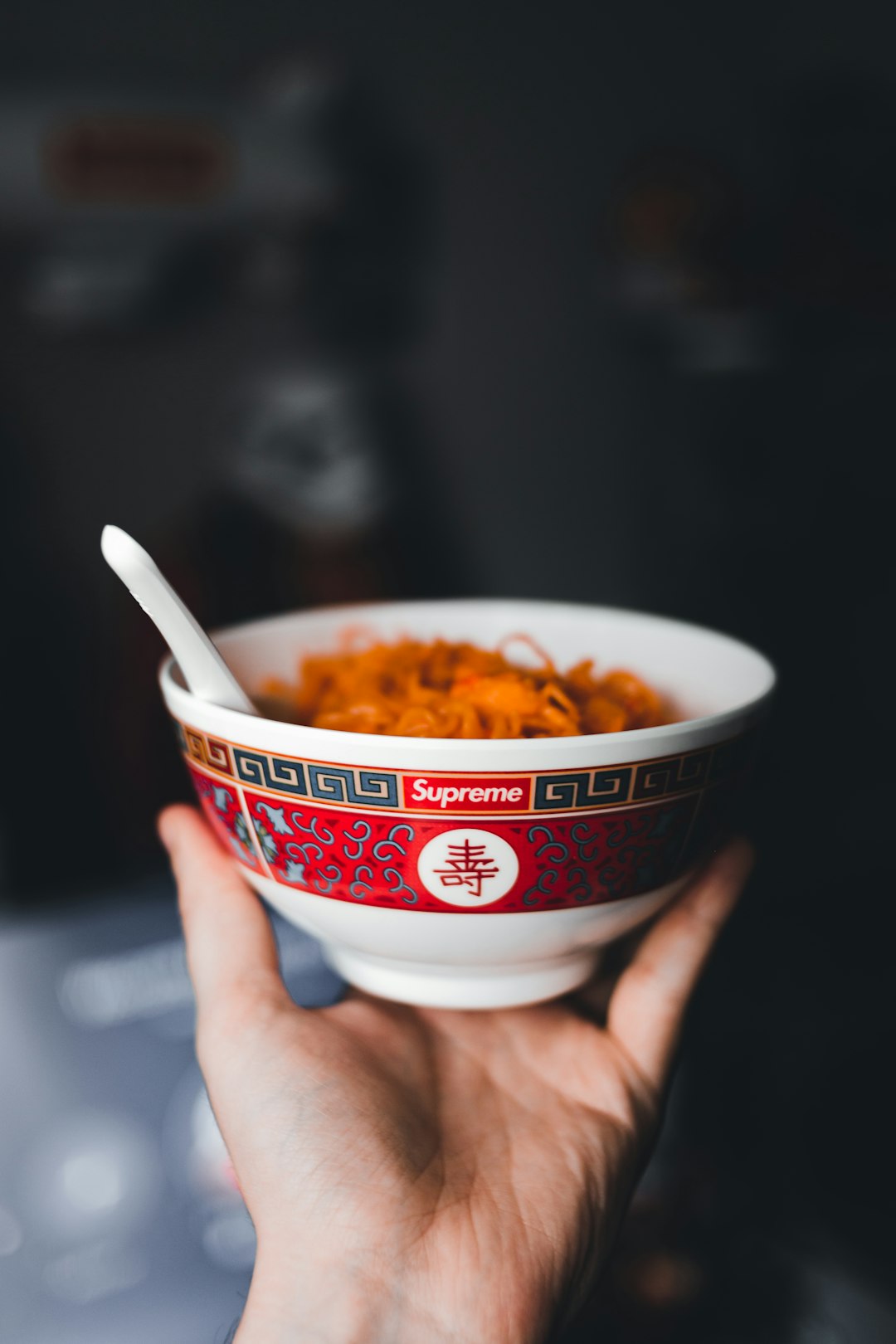 white and red ceramic bowl with pasta