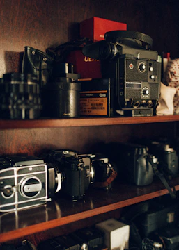 A camera lending library shelf filled with vintage and modern cameras.