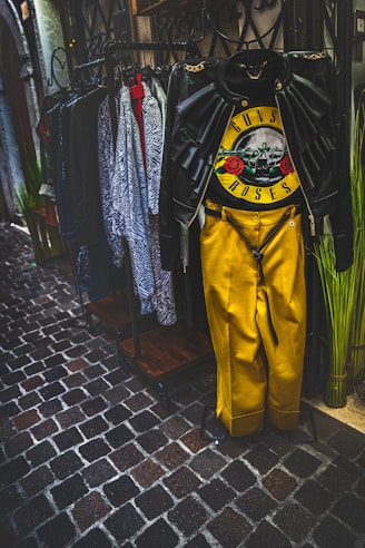 a yellow wetsuit hanging on a rack in a store