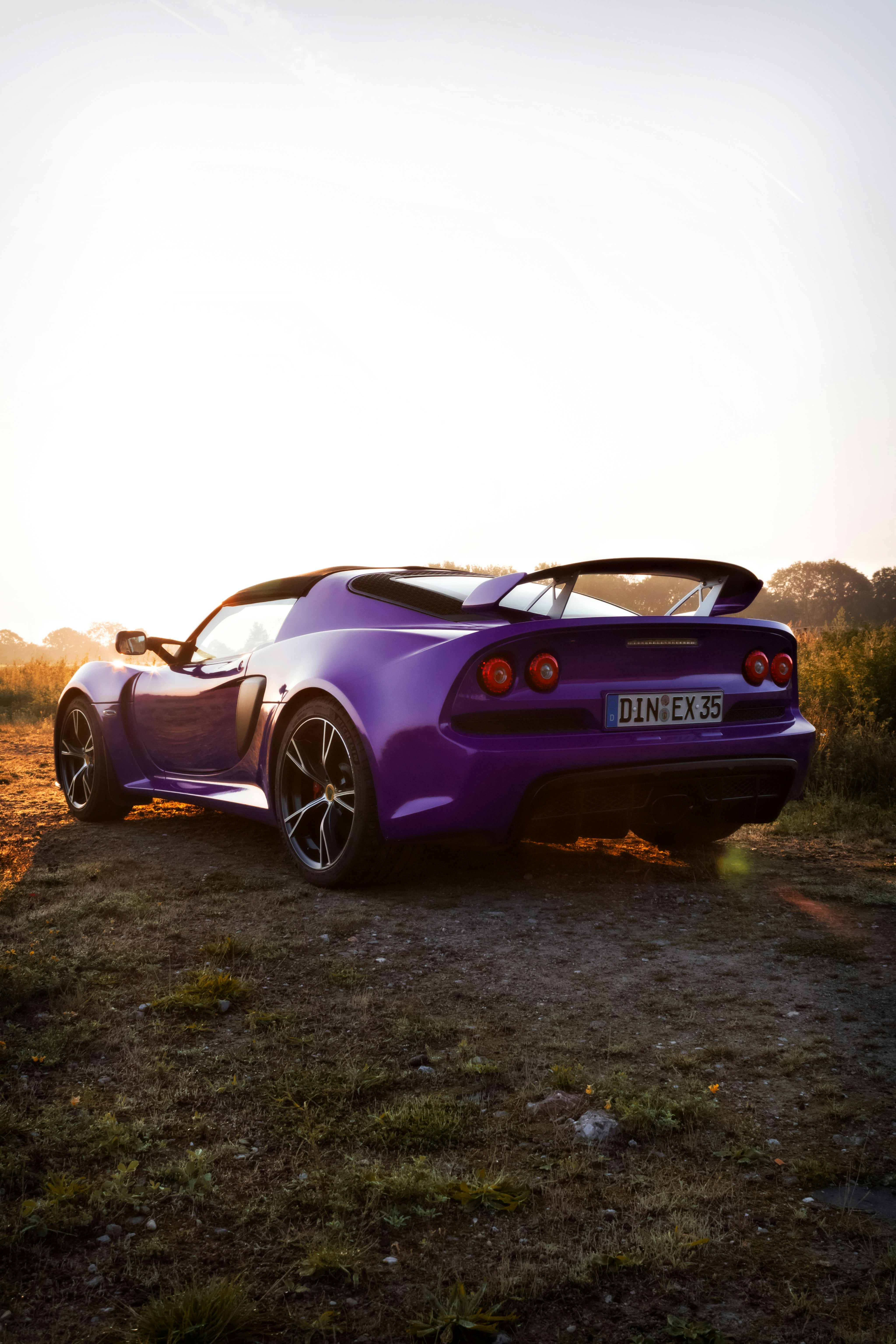 purple porsche 911 on green grass field during daytime