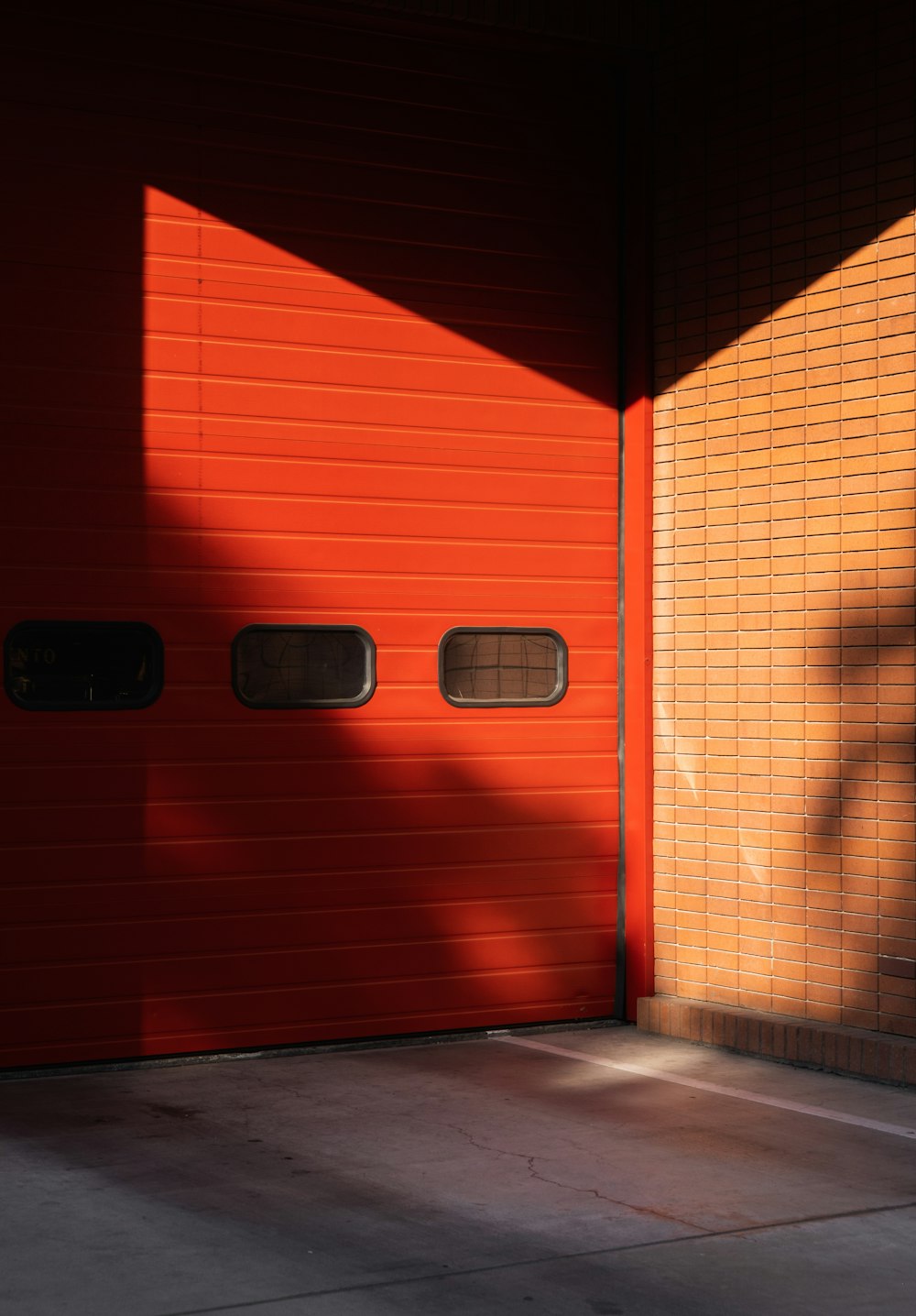 brown brick wall with black door