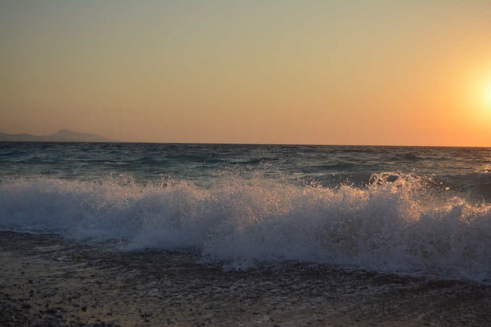 ocean waves under blue sky during daytime