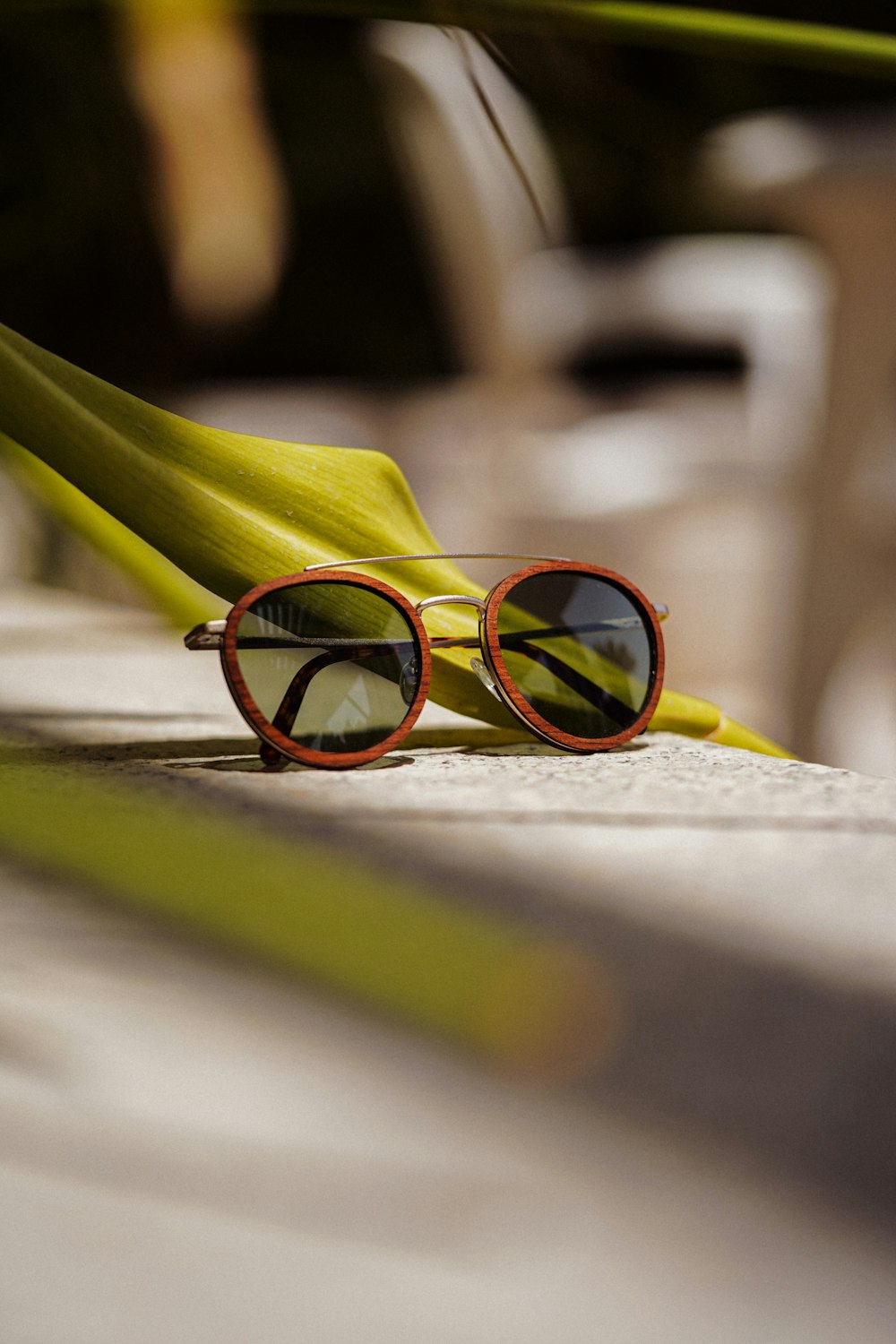 yellow framed sunglasses on white surface